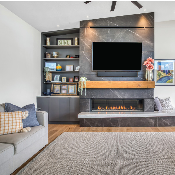 Modern home living room featuring a gray-tiled fireplace with TV built by Mike Riddle Construction Modern home living room featuring a gray-tiled fireplace with TV built by Mike Riddle Construction
