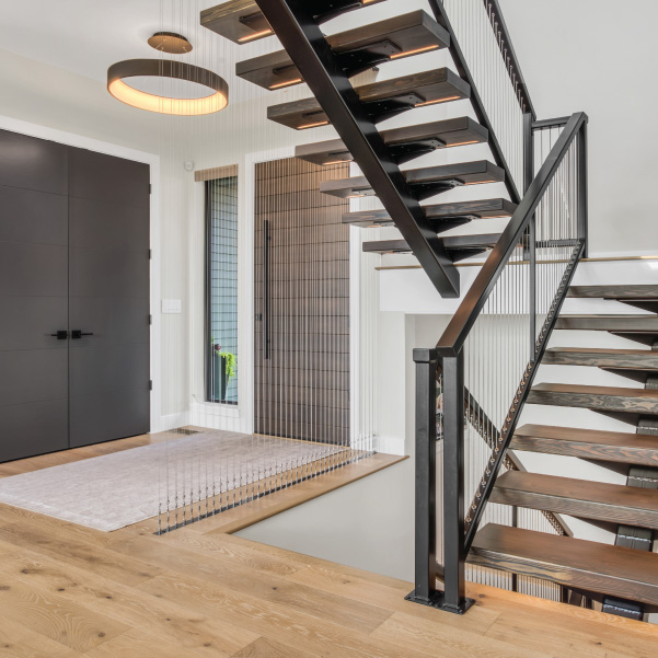 Front entry with a steel staircase in a custom home built by Mike Riddle Construction Front entry with a steel staircase in a custom home built by Mike Riddle Construction